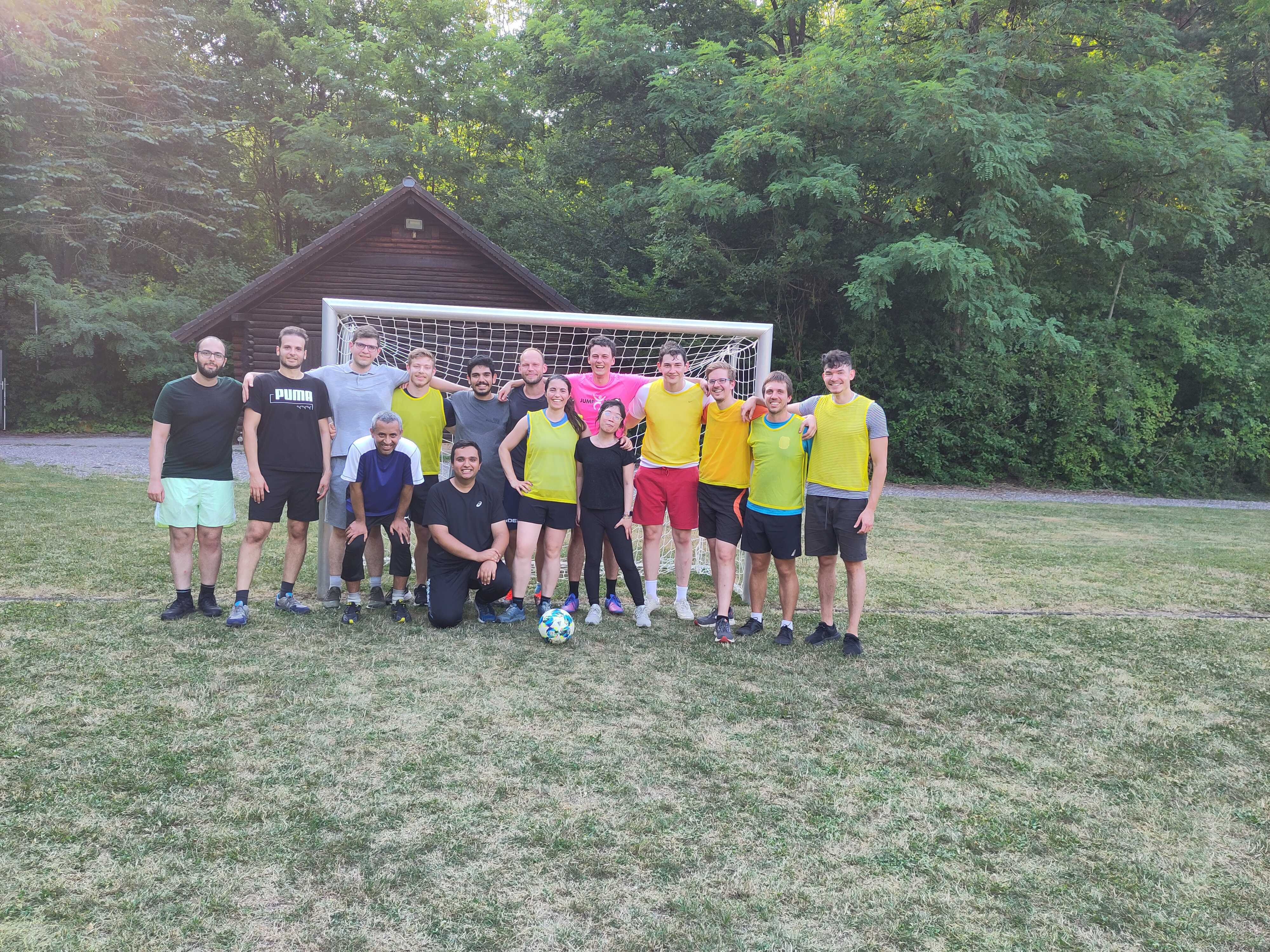 Team photo in the field, with everyone hugging